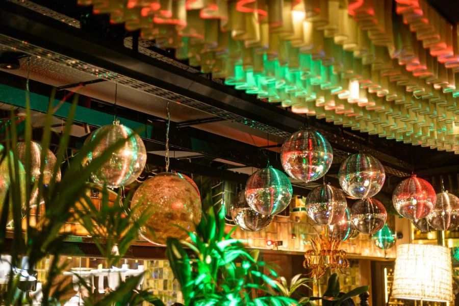 Hanging and rotating mirrors balls over a bar